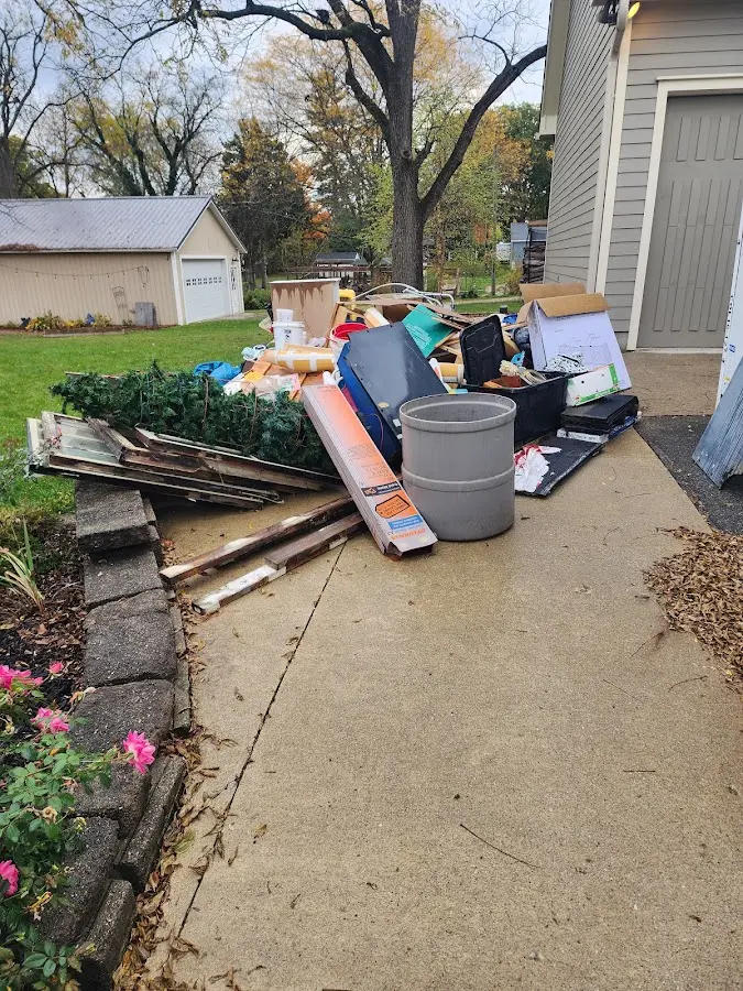 Dumpster being loaded with debris for Roofing Dumpster Rental in Fruitport